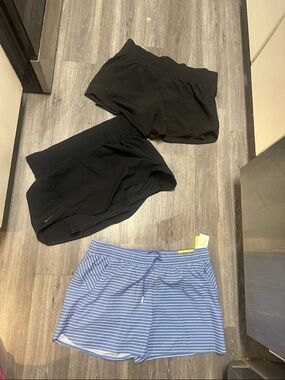 One pair of women’s Nike skirt with shorts under and other two are shorts
